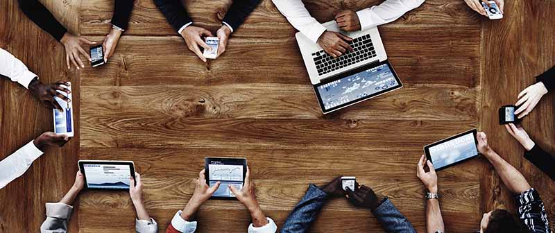 Group of Employees on their Technology Devices